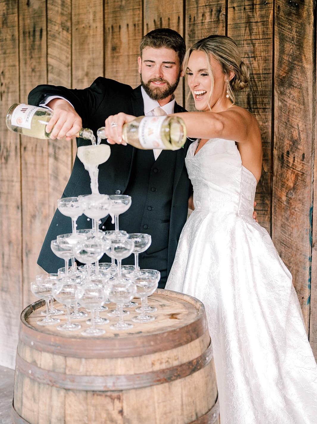 bride and groom pouring champagne tower