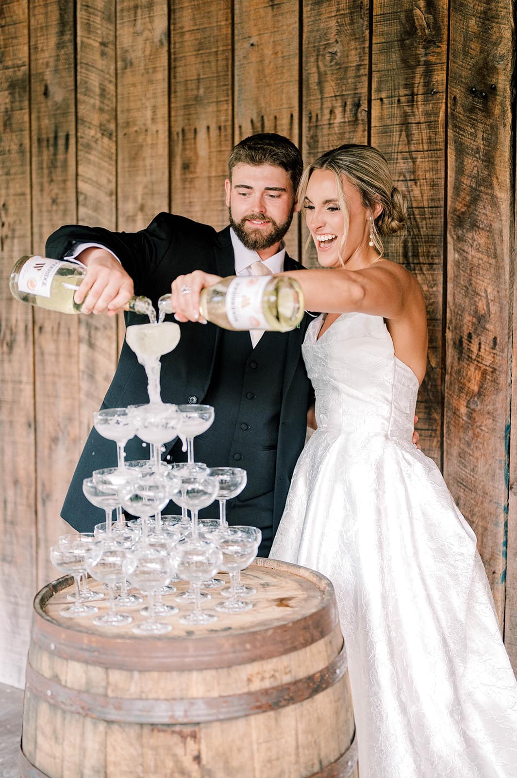 449146697_1000952495370684_8122346290526545641_n bride and groom pouring champagne tower