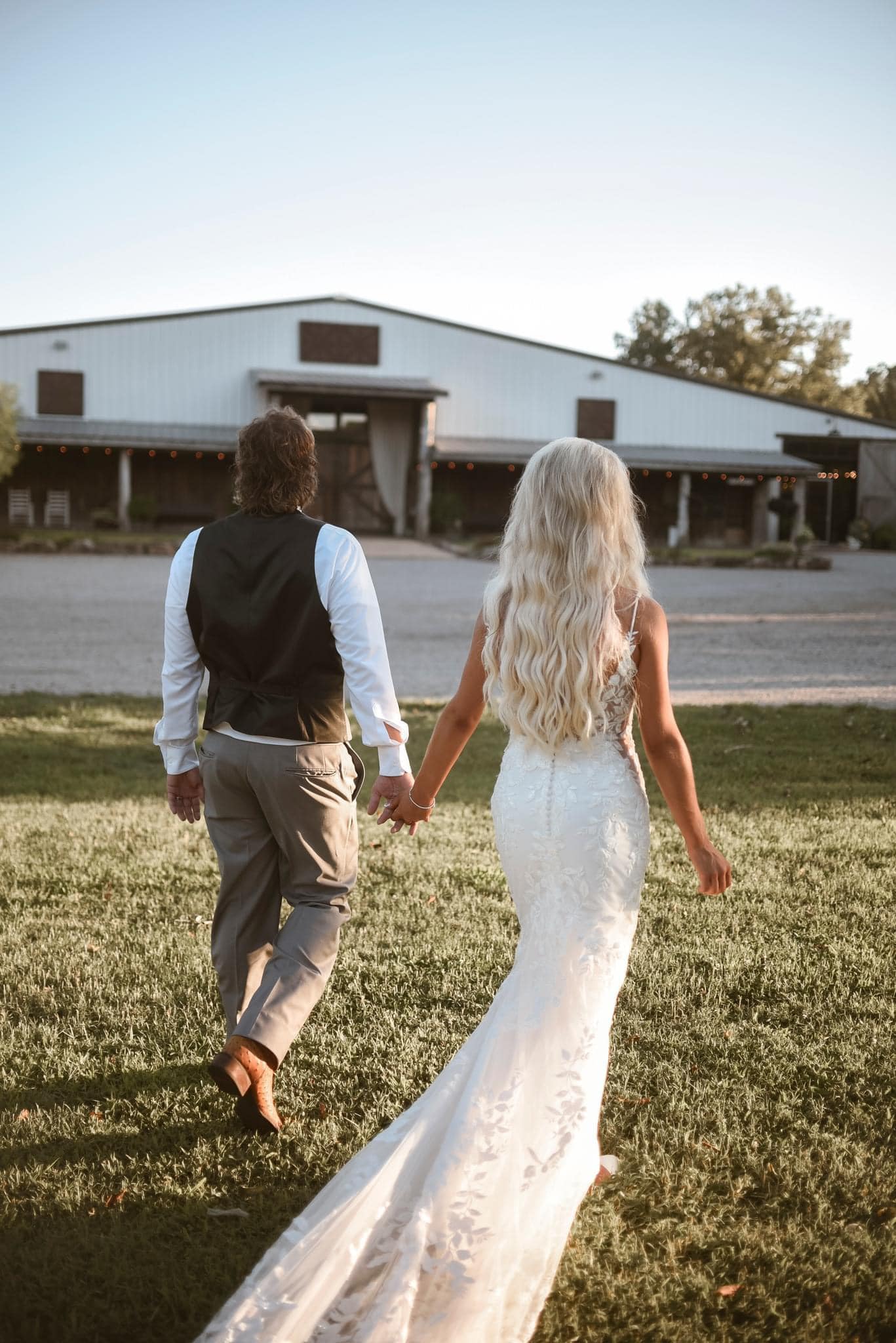 455830301_1036667321799201_7018517484934104516_n bride and groom walking and holding hands