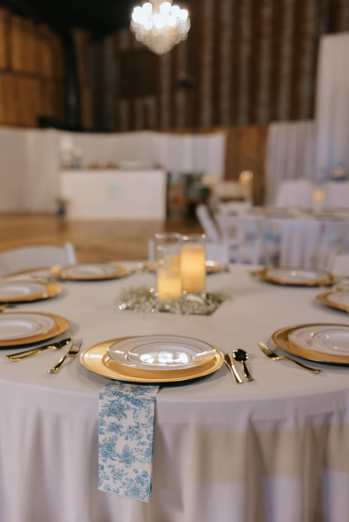 459303126_1057097019756231_3896121875832266773_n simple blue, white, and gold wedding reception tablescape