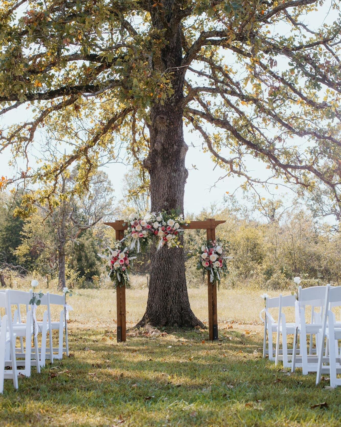 464751248_1099639578835308_5849047022855001654_n wooden arch with flowers for outdoor wedding